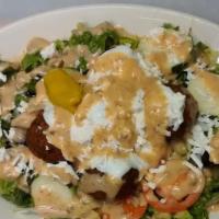 Large Falafel Salad · Greek salad topped with five falafel patties, tzatziki sauce and home made hummus dressing.