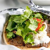Gyro Wrap · Made with pita bread and served with lettuce, tomatoes, onions and tzatziki sauce.