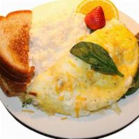 Veggie Omelet · Omelette stuffed with red peppers, green peppers, onions, spinach, mushrooms and cheese serv...