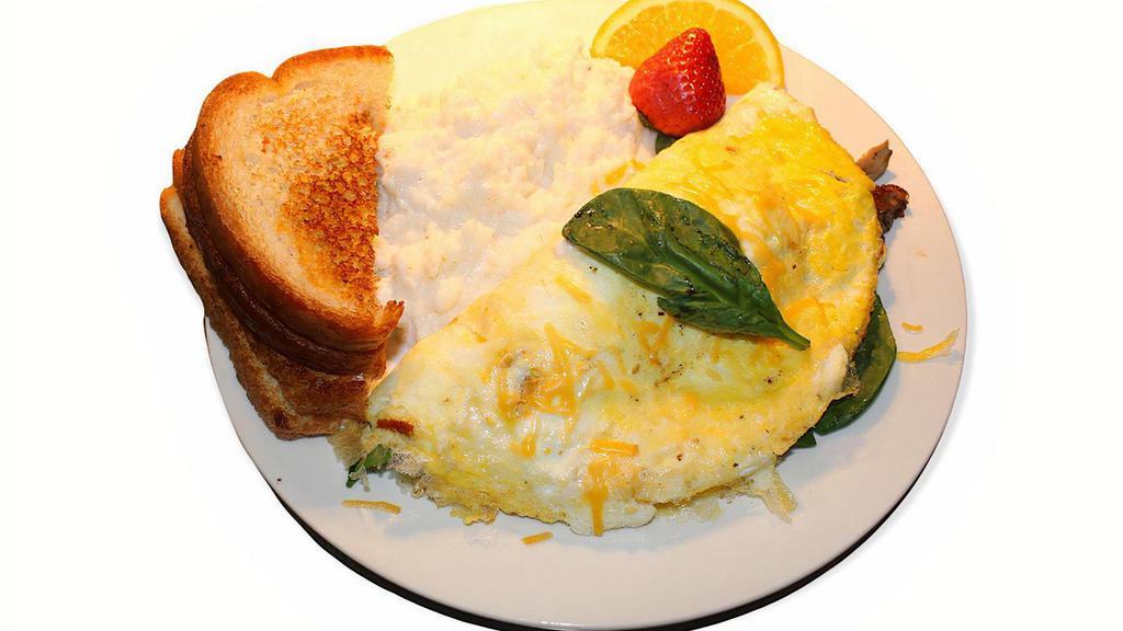 Veggie Omelet · Omelette stuffed with red peppers, green peppers, onions, spinach, mushrooms and cheese served with salsa