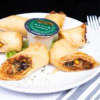 Black Bean Rolls · Hands down our most popular appetizer. Stuffed with chicken, corn, and a three-cheese blend ...