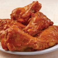Bone In Wings · Freshly baked chicken wings with your choice of flavor, and a side of dressing.