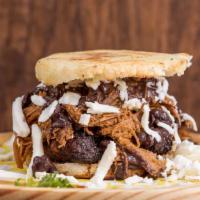Arepa Pabellón · Comes with Sweet plantains, Black beans, Shredded beef and Cheese.