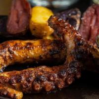 Grilled Octopus · Sous vide octopus, charcoal grilled, charred, and panca-anticuchera sauce.