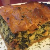 Spinach Pie · Spinach sauteed onions and feta cheese mixed and layered between filo dough and baked. Inclu...