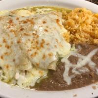 Enchiladas Suiza · 3 corn tortilla with chicken sauteed in ranchero sauce and topped with tomatillo sauce and m...