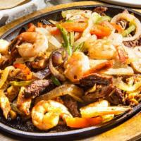 Fajitas · Your choice of meat on a sizzling platter with bell peppers and onions. Served with cheese, ...
