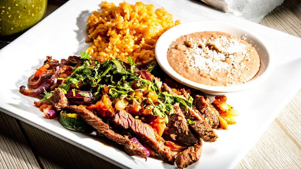 Bistec Ranchero · Spicy lover. Grilled steak strips, sautéed with onions, tomatoes, fresh jalapeños, and cilantro. Served with your choice of warm corn or flour tortillas. Served with a side of rice and beans.