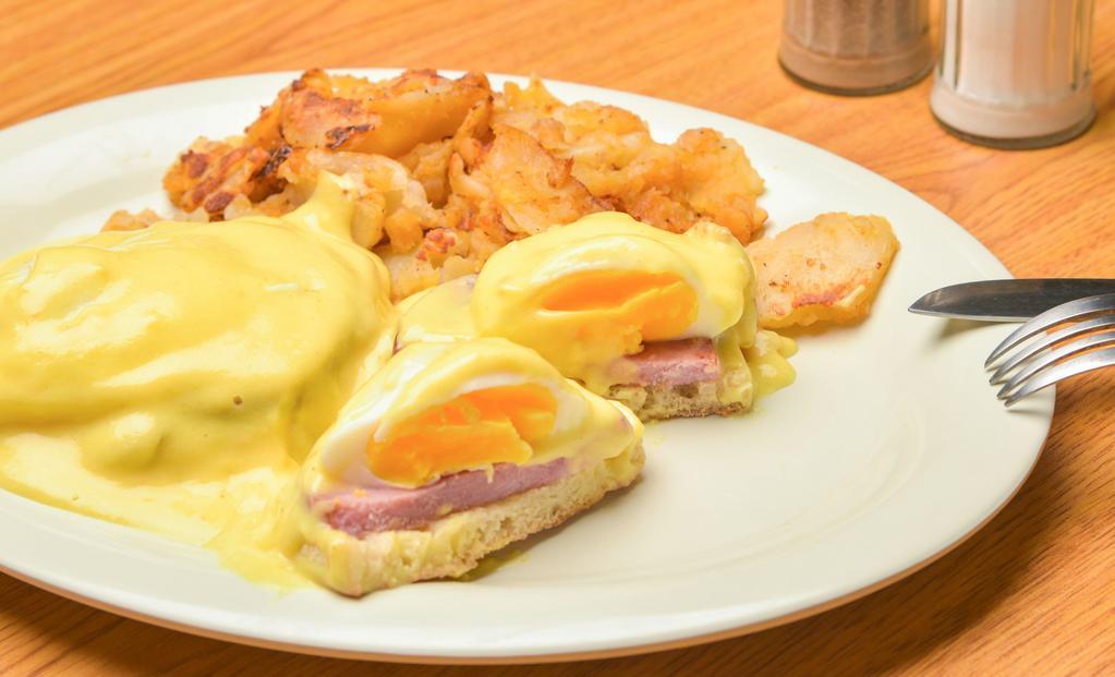 Eggs Benedict · Two poached eggs, Canadian bacon on English muffin with hollandaise sauce.