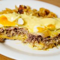 Cuban Eggs Benedict · Shredded pork over Cuban bread with ham, swiss cheese, pickles, mustard and two poached eggs...