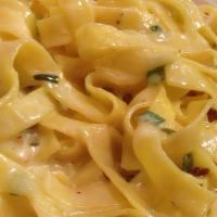 Fettuccine Carbonara · Fettuccine pasta sautéed with scallions and prosciutto in a white cream sauce.