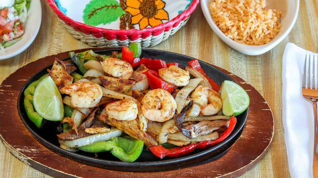 Fajita Texana · Grilled steak, chicken, shrimp, onions, bell peppers, served with rice, beans salad and corn tortillas.