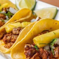 Tacos Al Pastor · (order of 3) Pork marinated in our delicious Pastor,. served in artisan corn tortilla accomp...