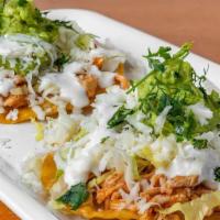 Tostada Tinga De Pollo · (Order of  3) Chicken prepared Mexico City style,. with lettuce, cheese, cream cheese and av...