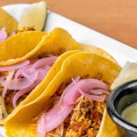 Tacos Cochinita Pibill · (Order of  3) Traditional Yucatan, Mexico style cochinita pibil,. served in artisan tortilla...