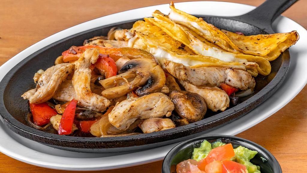 Fajitas De Pollo · Grilled chicken cooked with peppers, onion and mushrooms,. accompanied by 3 corn tortillas, guacamole and refried beans