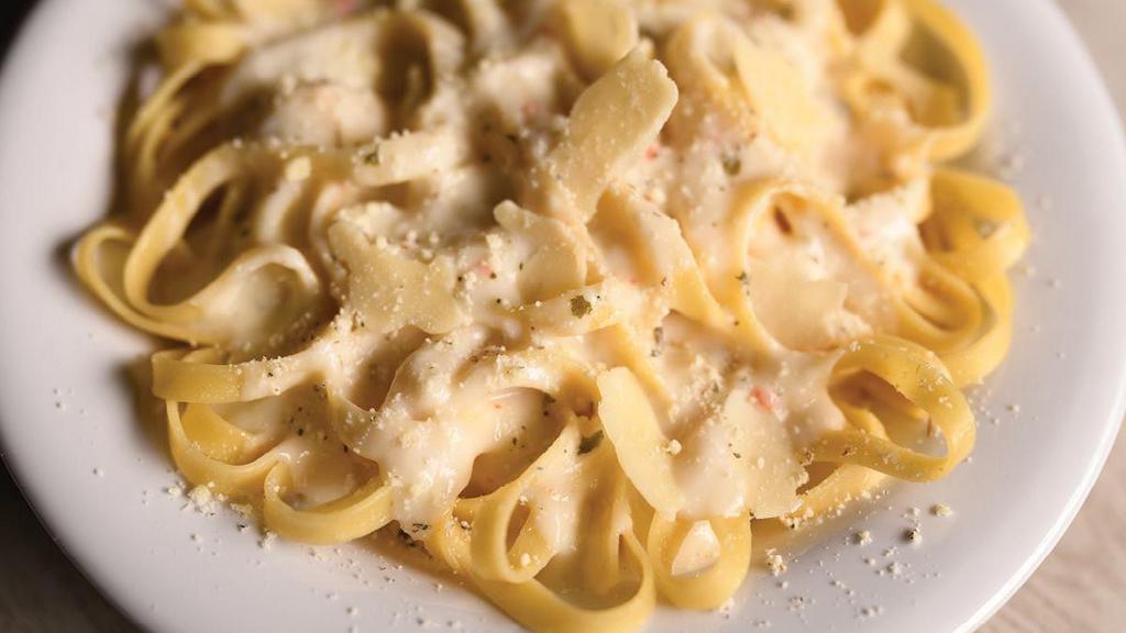 Small Fettuccine Alfredo · Fettuccine topped creamy garlic and parmesan Alfredo sauce topped with shaved Parmesan cheese and Italian herbs.. Includes 2 of our Signature Garlic Breadsticks
