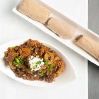 Tibs Firfir · Injera moistened with tender Steak cubes simmered to perfection in berbere sauce, fresh toma...