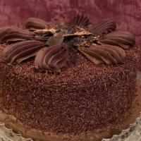Death By Chocolate Cake Slice · Flourless chocolate cake layers filled and decorated with kettle cooked fudge and Belgian ch...