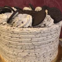 Oreo Cookies & Cream Cake Slice · White and Devil food cake filled and decorated with Oreo cookies and cream mousse.