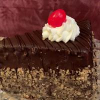 Boston Cream Cake Wedge · Moist yellow cake layers filled with a vanilla Boston cream, covered in chocolate ganache an...