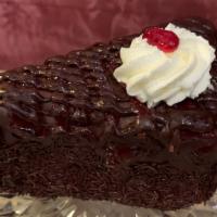 Raspberry Chocolate Cake Wedge · Chocolate chiffon cake layers filled with chocolate mousse, covered in raspberry chocolate g...