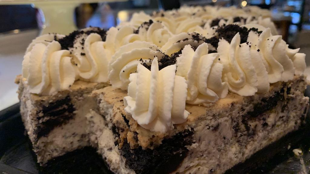 Oreo Cheesecake Bar · New York style cheesecake baked with Oreos and an Oreo crust, topped with whipped cream.