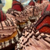 Strawberry Cupcake · Yellow cake topped with strawberry mousse, chocolate drizzle and a fresh strawberry.