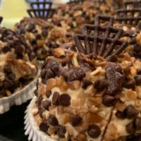 Turtle Cheesecake Cupcake · Devils food topped with whipped turtle cheesecake, rolled in chocolate chips and pecans, and...