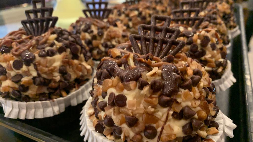 Turtle Cheesecake Cupcake · Devils food topped with whipped turtle cheesecake, rolled in chocolate chips and pecans, and drizzled with chocolate and caramel. DESSERT OF THE MONTH! 20% OFF!