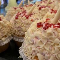 Raspberry Mousse Cupcake · White cake topped with raspberry mousse, rolled in white chocolate curls, and drizzled with ...