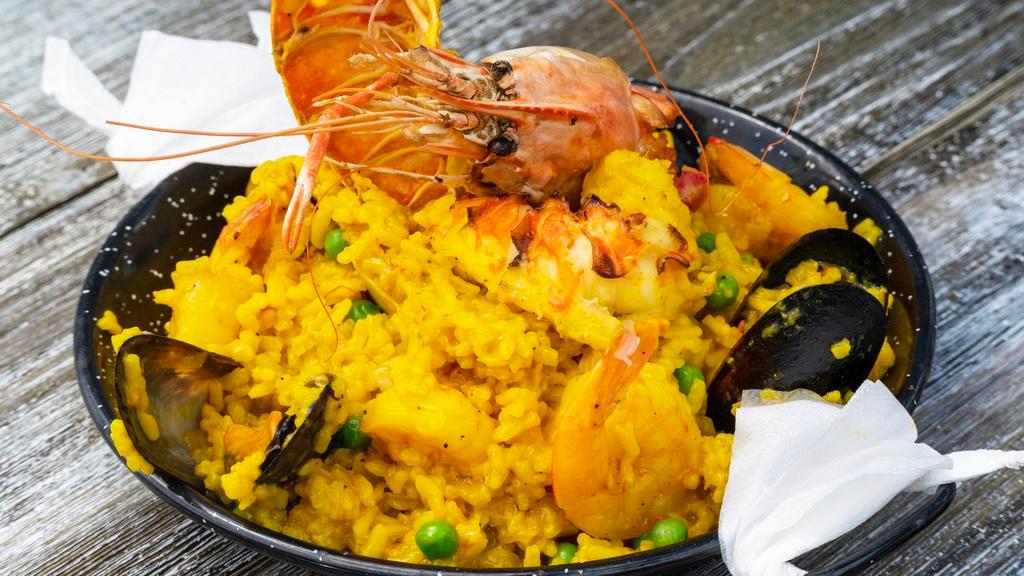 Paella De Mariscos · Autentico Plato de arroz Valencia con langosta, camarones, almejas, mejillones, calamares y vieiras.