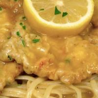 Veal Francese · Egg battered, sautéed with lemon herbs, butter and white wine sauce, served over pasta.