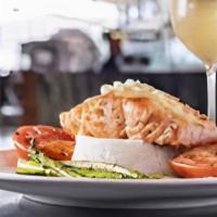 Salmon Francese · Egg battered, sautéed with lemon herbs, butter and white wine sauce, served over pasta.