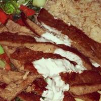  Beef-Lamb Rice Platter · Beef-lamb with basmati rice, salad and pita bread topped with taziki sauce.
