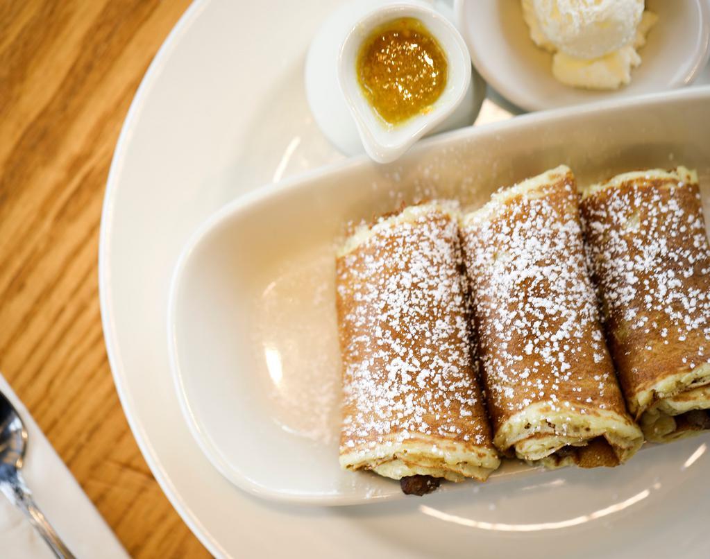 Three Little Pigs In A Blanket · Our special link sausages wrapped in buttermilk pancakes and dusted with powdered sugar. Served with whipped butter. 1120 cal.
