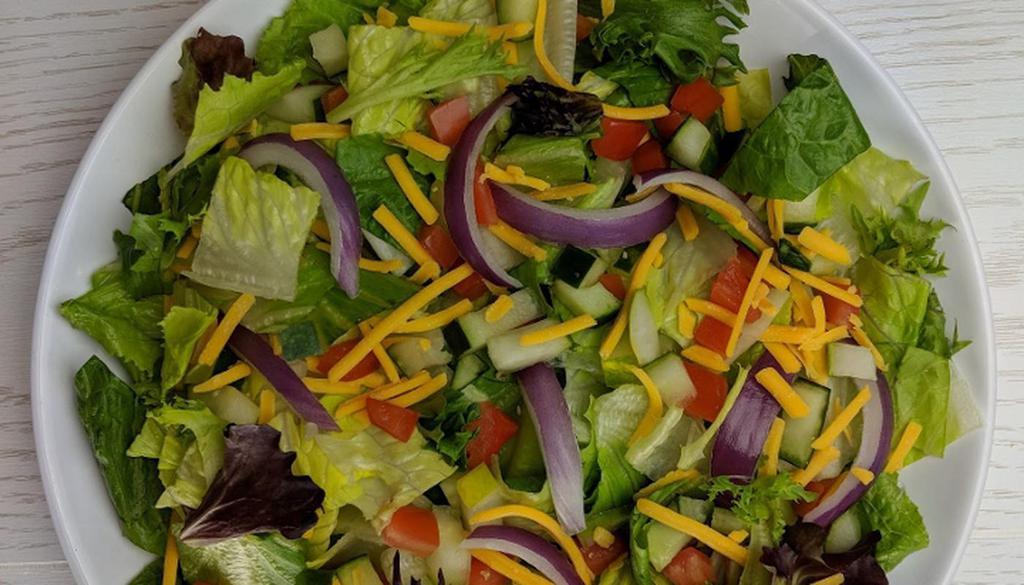 Garden Salad · Mixed greens, roma tomatoes, cucumbers, red onions, cheddar cheese, crostini and dressing of your choice.