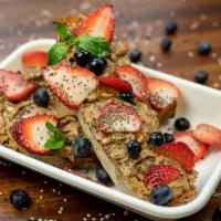 Mixed Berry Almond Butter Toast · Multigrain toast with almond butter spread topped with fresh strawberries, blueberries, chia...