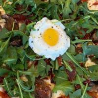 Protein Pizza · Tomato sauce base with mozzarella cheese, crispy prosciutto, arugula &  an egg on a cauliflo...