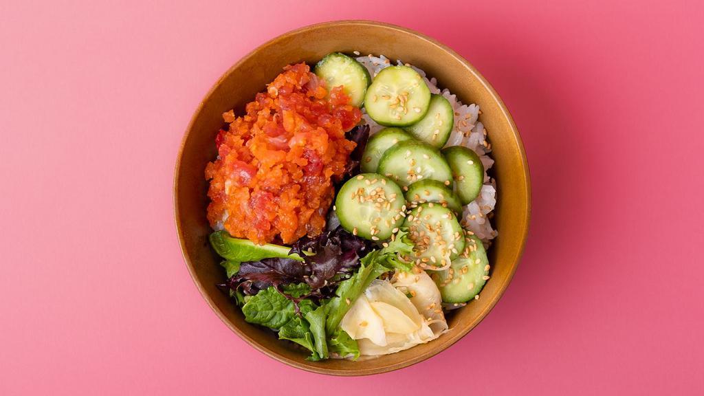 Spicy Tuna Rice Bowl · Spicy tuna over sushi rice with sliced cucumber, radish, ginger, crunchy greens, and sesame seeds.