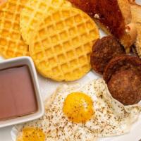 Waffles · Two eggs and choice of meat: sausage, bacon or ham.