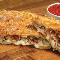 Chicken Classico Calzone · Stuffed with grilled chicken, bacon, onions and our signature three cheeses; served with a s...