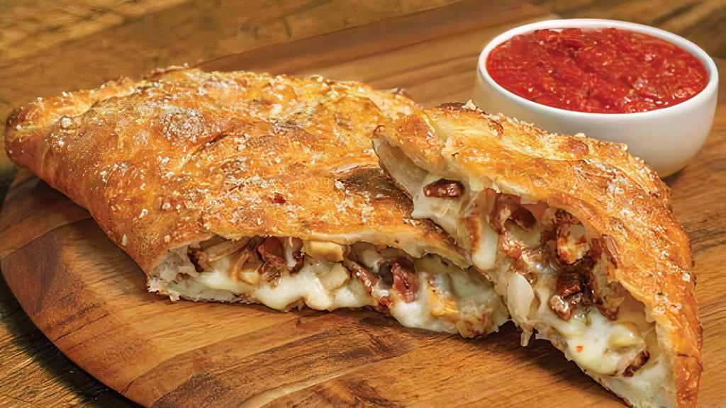 Chicken Classico Calzone · Stuffed with grilled chicken, bacon, onions and our signatures three cheeses; served with a side of our ranch dipping sauce