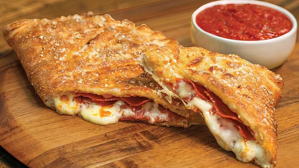 Pepperoni Calzone · Our handmade dough stuffed with pepperoni and our signature three cheeses; served with a side of our original pizza sauce. 960 cal.