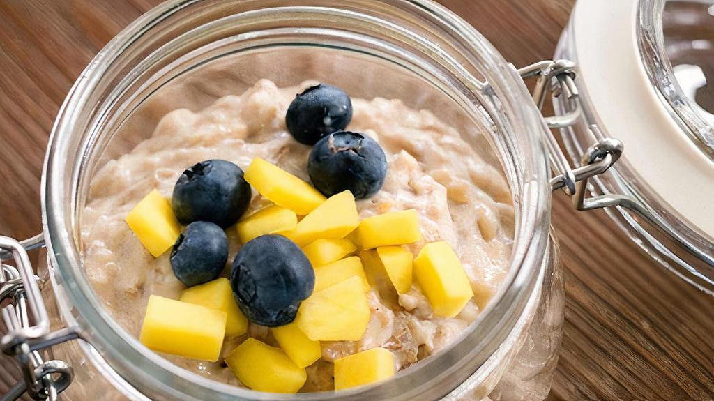 Coconut Rice Pudding (Gf) · Homemade coconut milk rice pudding, topped with fresh mango and blueberries