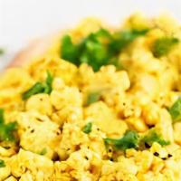 Tofu Eggless Scramble · Organic non-GMO tofu with red and green peppers, scallions, turmeric, served on top of a bed...