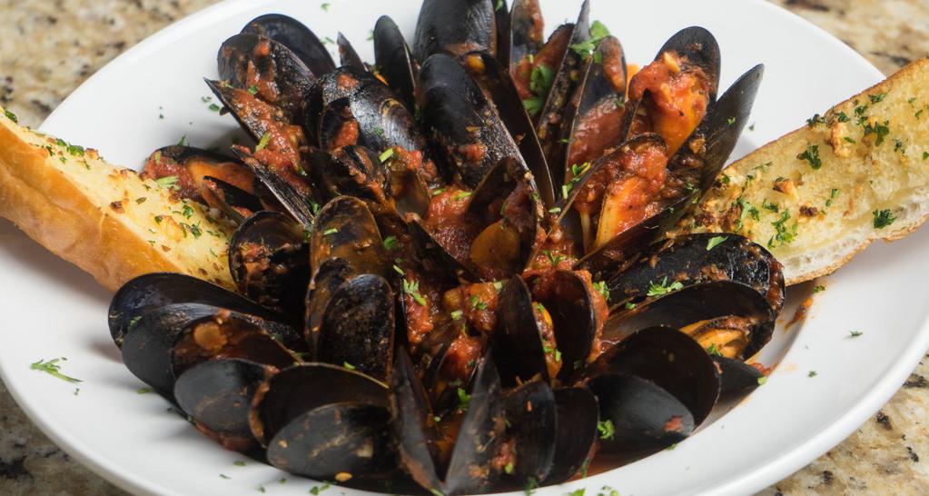 Mussels Marinara · 1 lb. of sautéed mussels in a spicy garlic white wine pomodoro sauce garnished with toasted bread.