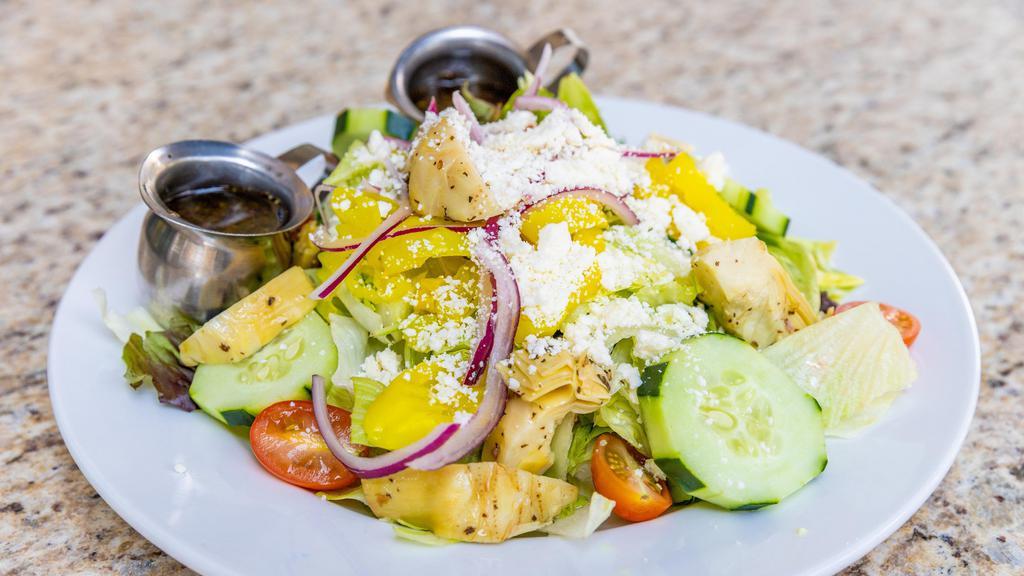 Greek Artichoke Salad · Mixed greens with marinated artichoke hearts, tomatoes, cucumbers, banana peppers, red onions, kalamata & green olives topped with feta cheese. Served with our Italian vinaigrette.