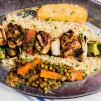 Chicken Kebob · Marinated char-grilled chicken cubed with grilled vegetables over a bed of rice.
