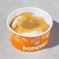 Mashed Potatoes With Gravy · Mashed potatoes covered with our flavorful cajun gravy.